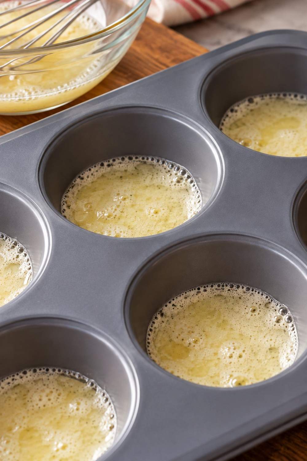 Frothed egg white mixture spooned thinly into a silicone muffin pan